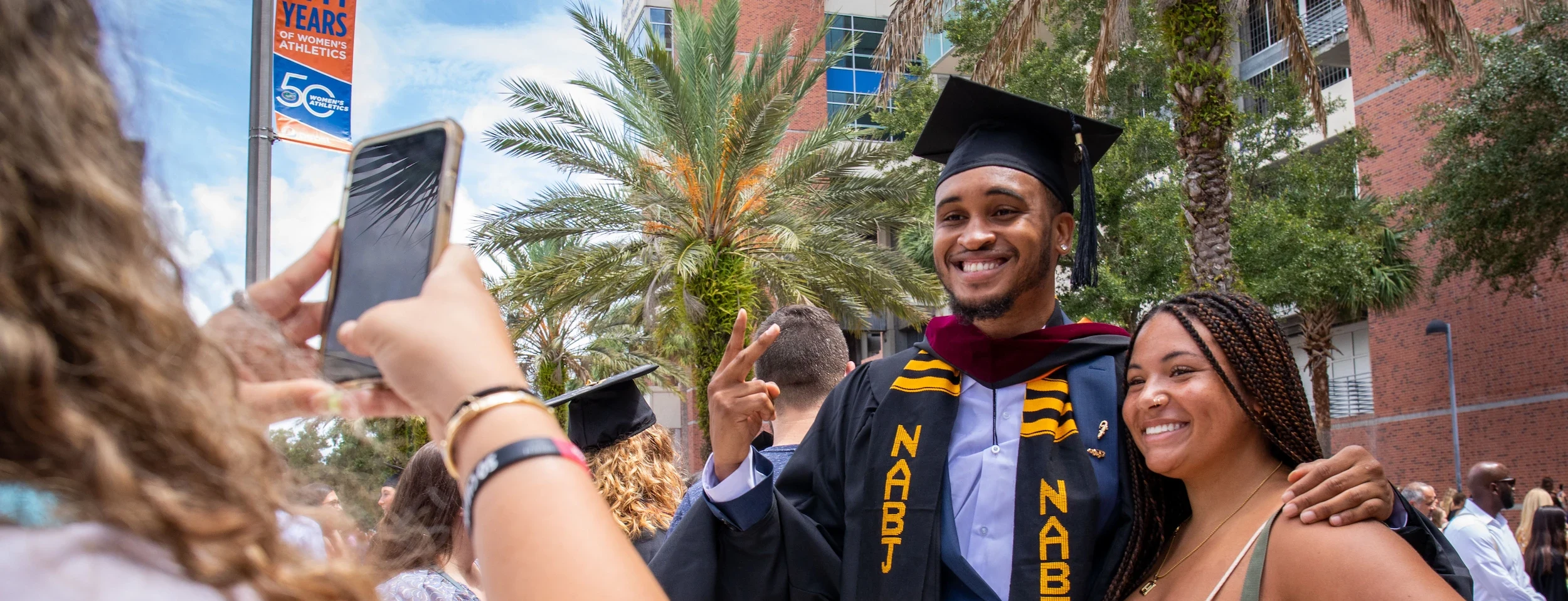 Student Smiling in cap and gown on graduation